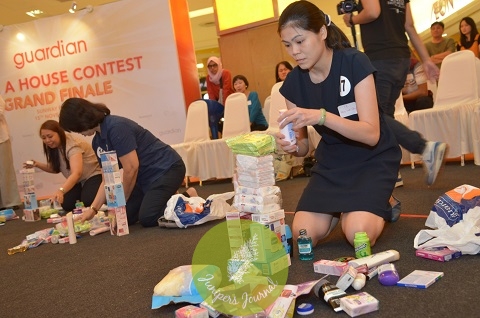 guardian-wah-finalists-stacking-a-tower-with-products-to-win-the-grand-prize-house