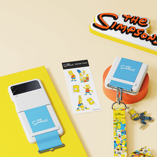 A silicone cover strap, lanyard and sticker pack that can be attached to a Galaxy Z Flip3 5G. Available in the following variations: •Galaxy Z Flip3 5G Star Wars Strap • Galaxy Z Flip3 5G Simpsons Strap 