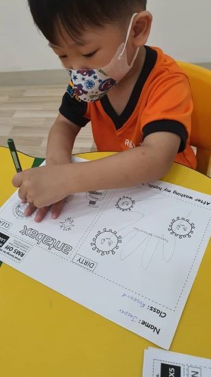 : A student of REAL Kids Bandar Makhota Cheras practicing good hygiene habits with her Antabax Care Kit