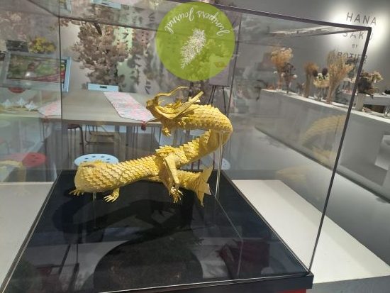 Majestic yellow dragon crafted from a single piece of paper and very expensive